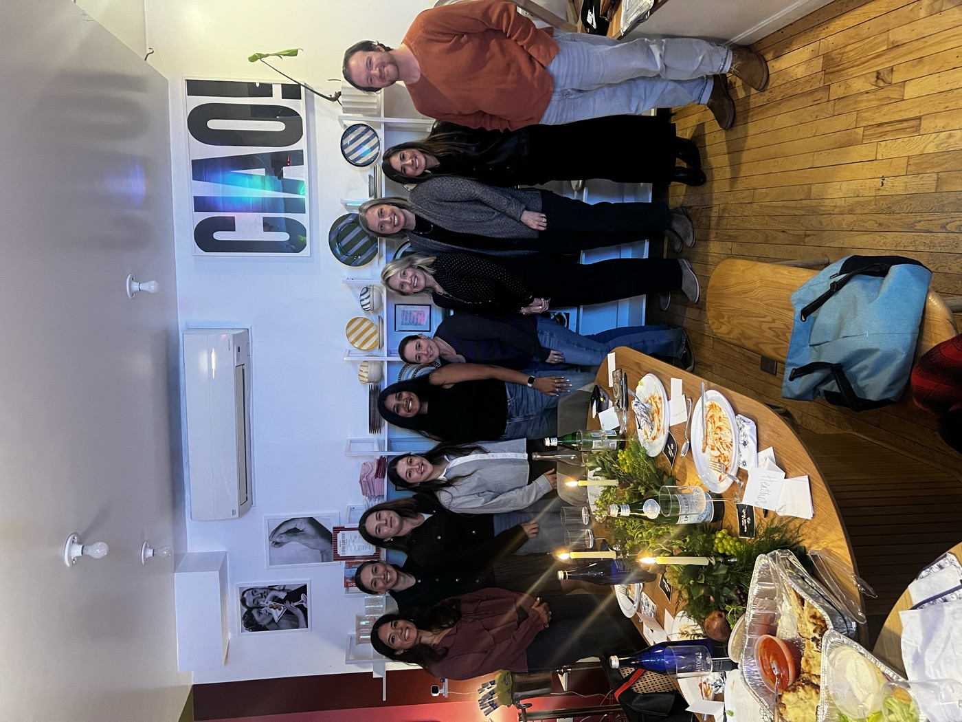 Group photo of attendees standing together in front of the CIAO! sign